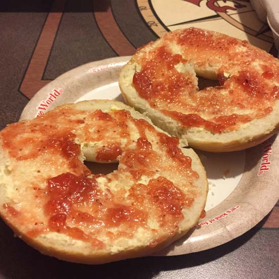 Bagel spread with butter and jam