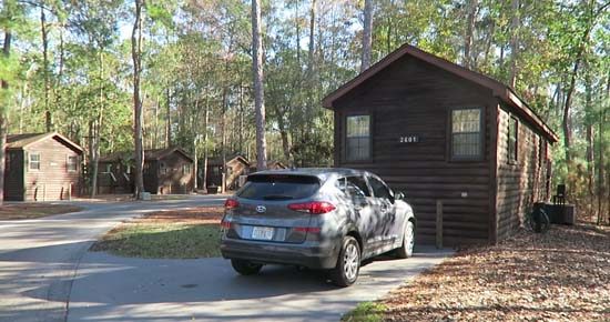 Outdoor view of the cabins at fort wilderness, with car parked in front