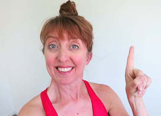 Yoga teacher with one finger pointing up