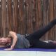 pilates teacher performing side lying leg lift