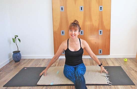 Yoga teacher sitting on a yoga mat