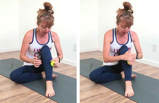 Yoga teacher using a tennis ball to massage shin muscles