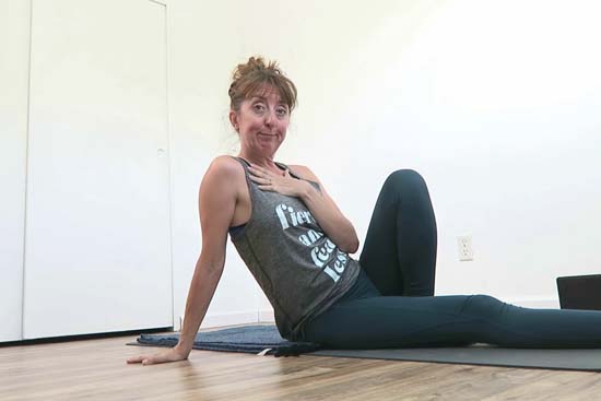 yoga teacher lounging on yoga mat
