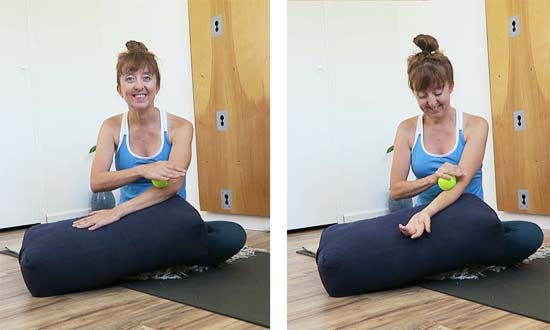seated with arm supported and rolling a tennis ball along forearms