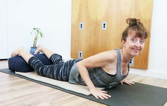 cobra pose with lower leg elevated on bolster