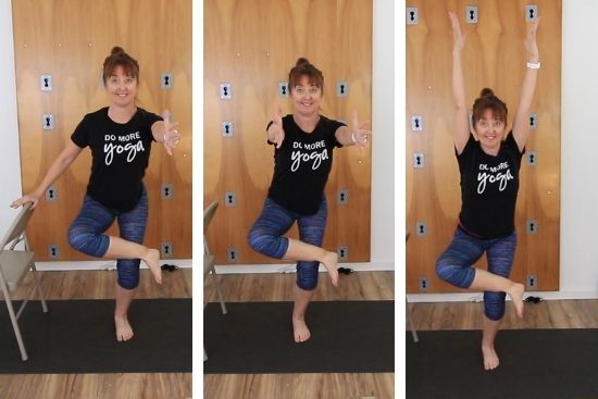 yoga teacher demonstrating standing pigeon pose with a chair
