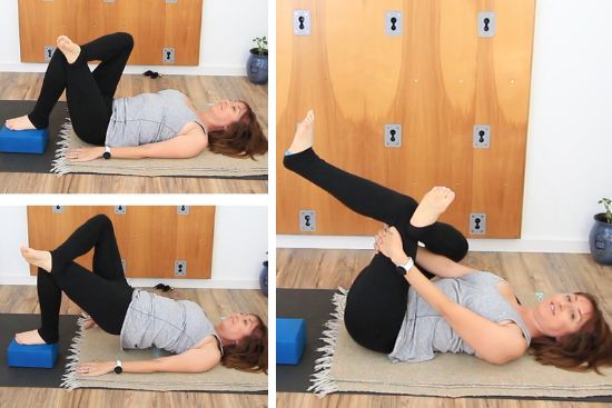 yoga teacher on a yoga mat demonstrating yoga exercises with yoga block